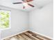This bedroom boasts wood-look floors, neutral walls, a ceiling fan, and a bright window at 127 Danielle Ct, Villa Rica, GA 30180