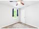 This bedroom features neutral walls, carpeted floors, a ceiling fan, and a bright window at 127 Danielle Ct, Villa Rica, GA 30180