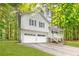 Exterior shot of a two-story home featuring an attached garage, white siding, and a cozy front porch at 127 Danielle Ct, Villa Rica, GA 30180