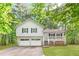 Charming two-story home featuring a welcoming front porch, attached two-car garage, and lush surrounding greenery at 127 Danielle Ct, Villa Rica, GA 30180