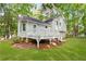 Back exterior of home featuring a deck and lots of trees at 127 Danielle Ct, Villa Rica, GA 30180