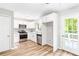 Modern kitchen featuring stainless steel appliances, white cabinets, granite countertops, and wood flooring at 127 Danielle Ct, Villa Rica, GA 30180