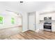 View of the kitchen with stainless steel appliances, wood flooring and white cabinets at 127 Danielle Ct, Villa Rica, GA 30180