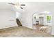 Open-concept living space with plush carpeting, staircase, and adjacent kitchen area with stainless steel appliances at 127 Danielle Ct, Villa Rica, GA 30180