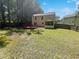 Expansive backyard with a wooden deck, screened-in porch, and lush lawn surrounded by mature trees at 1503 Colt Ridge Se Ln, Mableton, GA 30126