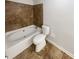 Tiled bathroom featuring a soaking tub, toilet, and tiled floors at 1503 Colt Ridge Se Ln, Mableton, GA 30126