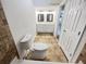 Tiled bathroom featuring double vanity sinks, toilet, and tiled floors at 1503 Colt Ridge Se Ln, Mableton, GA 30126