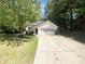 Charming single-story home with a two-car garage and a long driveway nestled among mature shade trees at 1503 Colt Ridge Se Ln, Mableton, GA 30126