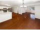 Open living space with hardwood floors, neutral walls, and a modern chandelier at 1503 Colt Ridge Se Ln, Mableton, GA 30126