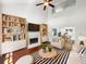 Bright living room with a fireplace, hardwood floors, and vaulted ceilings is staged with tasteful decor at 1503 Colt Ridge Se Ln, Mableton, GA 30126