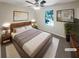 Cozy main bedroom featuring a ceiling fan and plush carpet, staged with a bed and side tables at 1503 Colt Ridge Se Ln, Mableton, GA 30126
