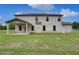Expansive backyard showcasing a covered patio and lush green lawn at 157 Haverling Pass, Hampton, GA 30228