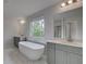 Elegant bathroom showcasing a soaking tub, dual sinks, and a large window at 157 Haverling Pass, Hampton, GA 30228