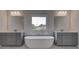 Spa-like bathroom with soaking tub, dual vanities and large mirrors at 157 Haverling Pass, Hampton, GA 30228