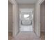 Bright bathroom showcasing a large soaking tub and walk-in closets at 157 Haverling Pass, Hampton, GA 30228