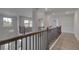 Hallway area with wood floors, modern railings and bright, open aesthetic at 157 Haverling Pass, Hampton, GA 30228