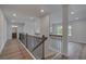 Bright hallway featuring wood floors, modern lighting, and an open view of the home's layout at 157 Haverling Pass, Hampton, GA 30228