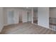 Bright hallway with wood floors showcases open access to other rooms at 157 Haverling Pass, Hampton, GA 30228