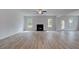 Spacious living room with a fireplace, wood floors, and large windows at 157 Haverling Pass, Hampton, GA 30228