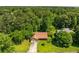 Aerial view of home and front yard, surrounded by mature trees at 2617 Laurel Woods Se Ln, Conyers, GA 30094