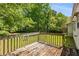 View of the home's back deck, overlooking the tree-lined backyard at 2617 Laurel Woods Se Ln, Conyers, GA 30094
