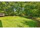 Large grassy back yard featuring mature trees and shade at 2617 Laurel Woods Se Ln, Conyers, GA 30094