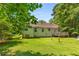 Grassy back yard and rear exterior view of home and wood deck at 2617 Laurel Woods Se Ln, Conyers, GA 30094