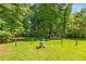 Expansive back yard with mature trees, perfect for outdoor activities at 2617 Laurel Woods Se Ln, Conyers, GA 30094