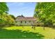 View of a ranch-style home and lush backyard with a well-maintained lawn and a small wooden deck at 2617 Laurel Woods Se Ln, Conyers, GA 30094