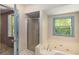 Bright bathroom featuring a jacuzzi tub and a shower stall at 2617 Laurel Woods Se Ln, Conyers, GA 30094