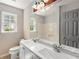 Bright bathroom featuring double sinks, a large mirror, and a window providing natural light at 2617 Laurel Woods Se Ln, Conyers, GA 30094