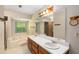 Bathroom boasting a jacuzzi tub and a wooden cabinet with a white countertop at 2617 Laurel Woods Se Ln, Conyers, GA 30094