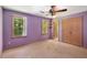 Bedroom featuring two windows with green views and a closet at 2617 Laurel Woods Se Ln, Conyers, GA 30094