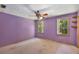 Bedroom with natural light, ceiling fan, and neutral carpet at 2617 Laurel Woods Se Ln, Conyers, GA 30094