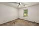Neutral bedroom with carpeted floors, a single window, and a ceiling fan at 2617 Laurel Woods Se Ln, Conyers, GA 30094