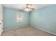 Cozy bedroom with a light blue wall, carpet floor, and ample natural light at 2617 Laurel Woods Se Ln, Conyers, GA 30094