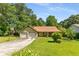 Charming one-story home featuring an attached two-car garage, mature trees, and a well-maintained lawn at 2617 Laurel Woods Se Ln, Conyers, GA 30094