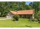 Charming one-story home featuring an attached two-car garage, mature trees, and a well-maintained lawn at 2617 Laurel Woods Se Ln, Conyers, GA 30094