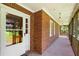 Inviting front porch with brick accents, white trim, and ample space for outdoor seating at 2617 Laurel Woods Se Ln, Conyers, GA 30094