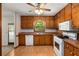 Traditional kitchen with wood cabinets, laminate countertops, and matching white appliances at 2617 Laurel Woods Se Ln, Conyers, GA 30094