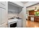 Convenient laundry closet with side-by-side washer and dryer near the open kitchen area at 2617 Laurel Woods Se Ln, Conyers, GA 30094