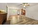 Bright living room with a fireplace, hardwood-style flooring, and an open view to the adjacent kitchen at 2617 Laurel Woods Se Ln, Conyers, GA 30094