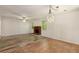 Spacious living room with hardwood floors, brick fireplace, and a modern chandelier at 2617 Laurel Woods Se Ln, Conyers, GA 30094