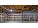 Unfinished basement with open ceiling, shelving units and concrete floor, ready for customization at 4516 Creekwood Circle Nw, Kennesaw, GA 30152