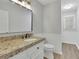 Granite countertops and a modern faucet highlight this bathroom with a toilet and sink at 4516 Creekwood Circle Nw, Kennesaw, GA 30152