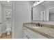 Bathroom featuring new light fixtures, granite countertops, white cabinetry, and updated flooring at 4516 Creekwood Circle Nw, Kennesaw, GA 30152