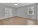 Bright bedroom with a ceiling fan, light walls, and access to a private balcony at 4516 Creekwood Circle Nw, Kennesaw, GA 30152