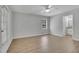 Spacious bedroom featuring hardwood floors, a ceiling fan, a window, and an ensuite bathroom at 4516 Creekwood Circle Nw, Kennesaw, GA 30152