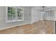 Dining room showcasing new wood flooring and a large window offering natural light at 4516 Creekwood Circle Nw, Kennesaw, GA 30152