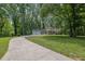 A picturesque home with an attached two-car garage, nestled amidst a lush, wooded landscape at 4516 Creekwood Circle Nw, Kennesaw, GA 30152